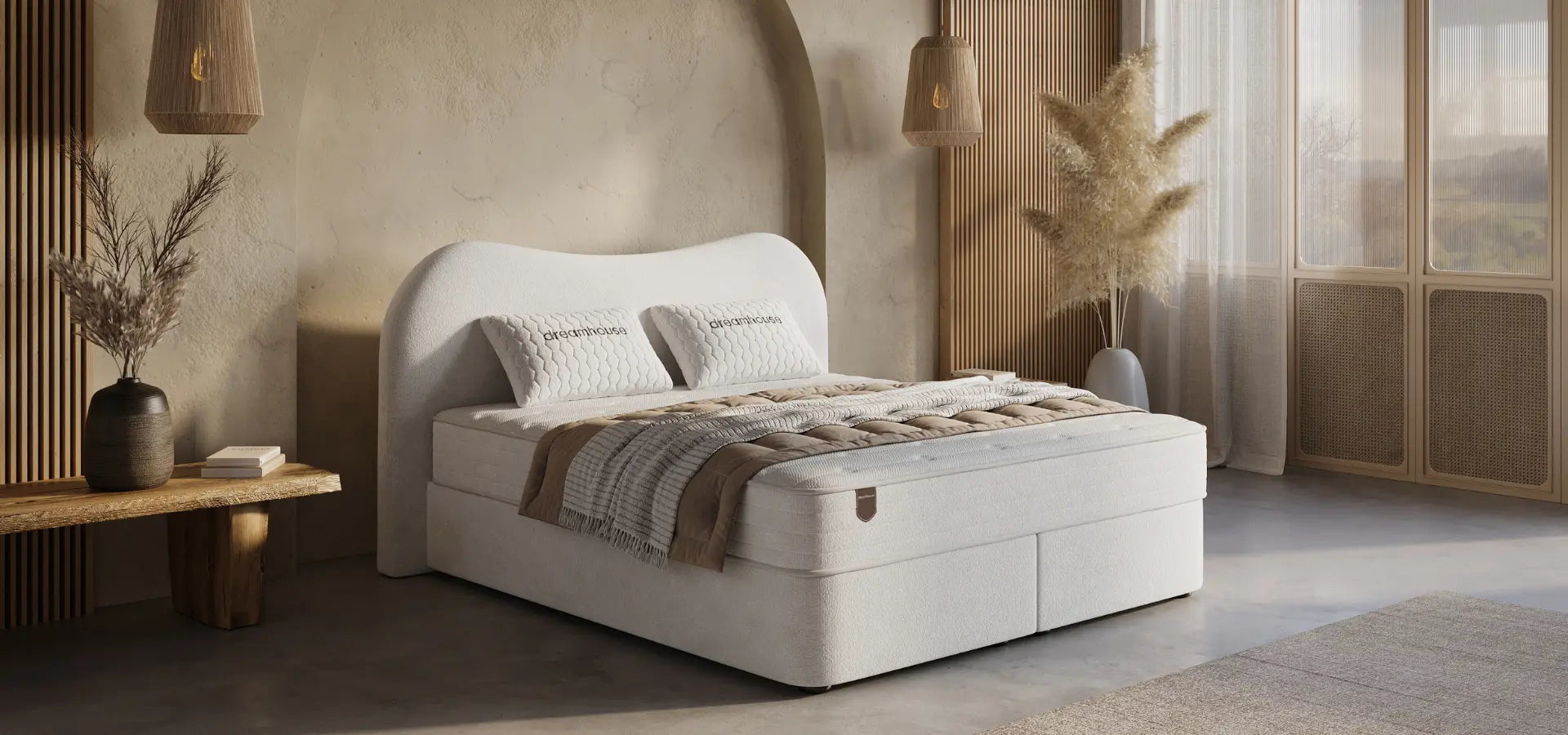 White bed with brown bedding in a modern bedroom setting